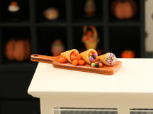 Load image into Gallery viewer, Halloween Cornucopia and Cream Horn on Orange Board - Handmade Miniature Food for 12th Scale Dollhouse