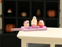 Load image into Gallery viewer, Three Pink Halloween Cupcakes (Glowing Ghost) on Pink Board - Handmade Miniature Food for 12th Scale Dollhous