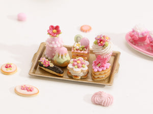 Beautiful presentation of pink miniature French pastries and treats on gold tray – Miniature Food