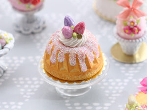 Easter Kouglof decorated with pink egg meringue nest and sparkly frosting