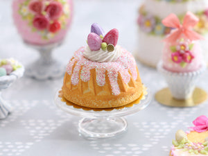 Easter Kouglof decorated with pink egg meringue nest and sparkly frosting