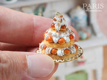 Load image into Gallery viewer, Triple Tiered St Honoré Pastry Centerpiece - Miniature Food in a hand to show 12th scale