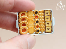 Load image into Gallery viewer, A hand holding a metal tray of miniature food cookies made from polymer clay